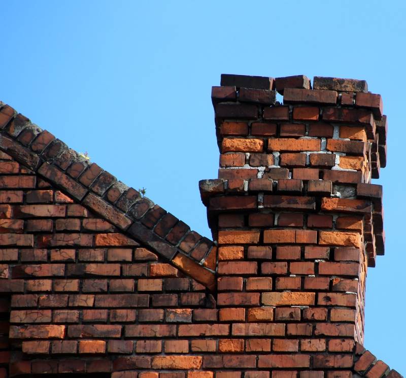 Signs Your Medford Home Needs a Chimney Inspection Damaged chimney on an Medford home showing cracks and missing mortar